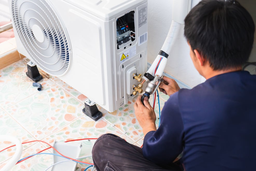 Air conditioning technicians install new air conditioners in homes, Repairman fix air conditioning systems, Male technician service for repair and maintenance of air conditioners