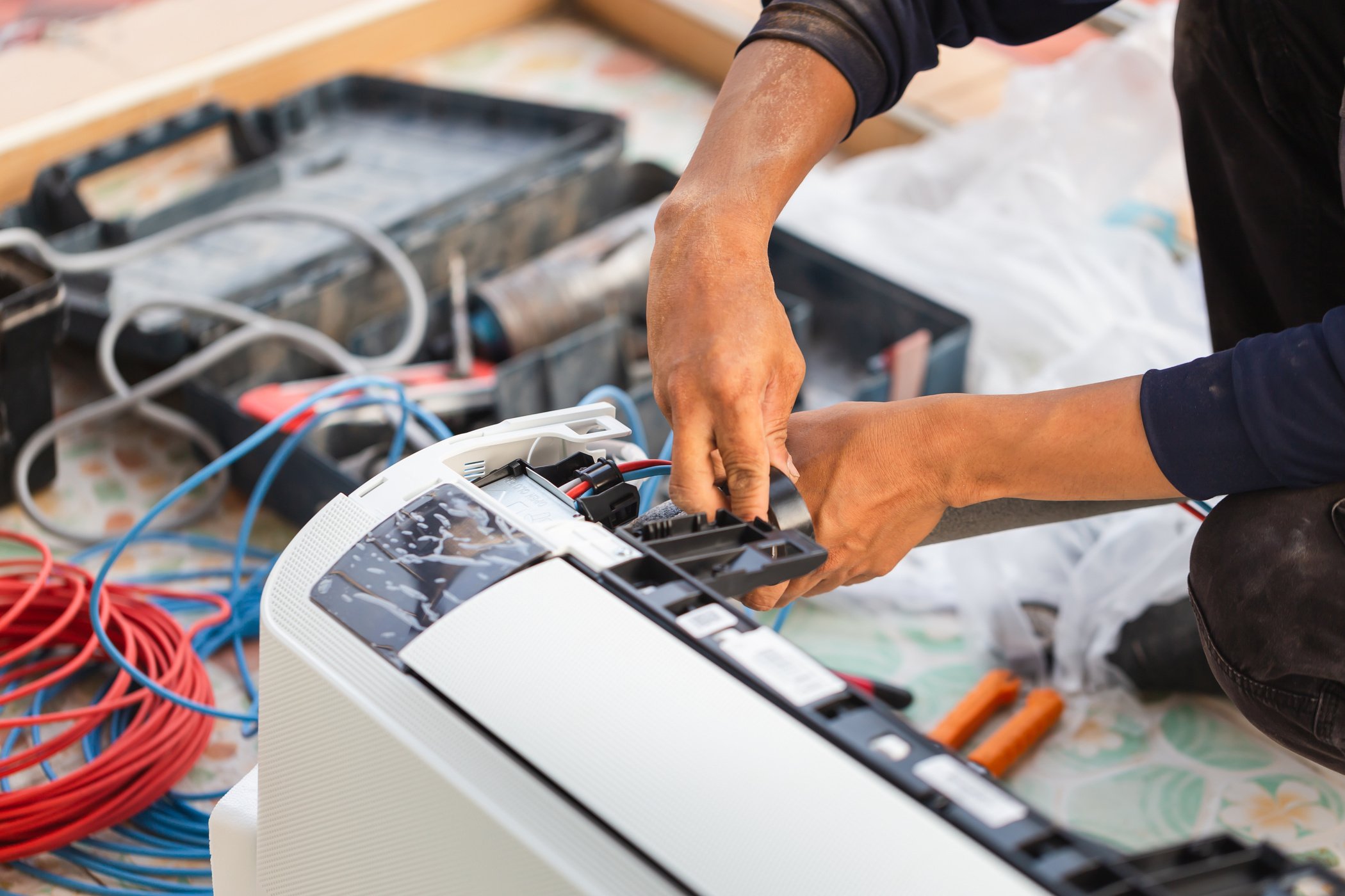 Air conditioning technicians install new air conditioners in homes, Repairman fix air conditioning systems, Male technician service for repair and maintenance of air conditioners